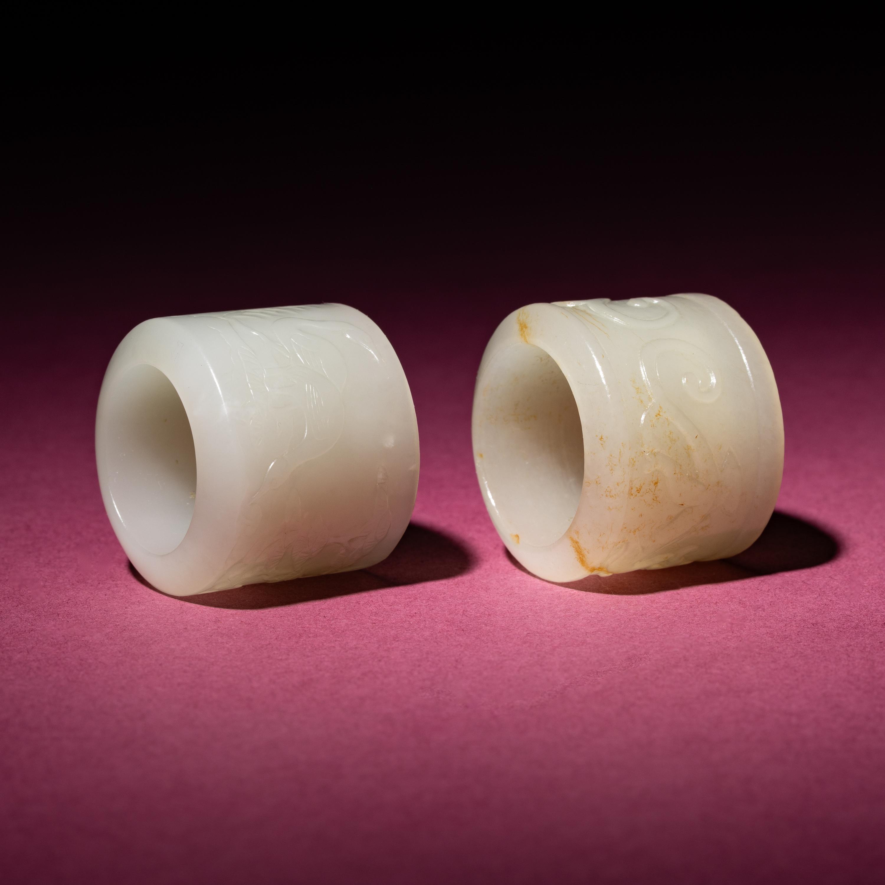 Two Chinese White Jade 'Animal' Archer's Rings, 18th Century — 清中期 白玉刻動物紋扳指兩枚