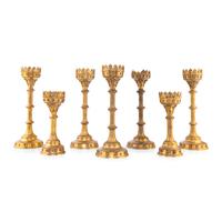 A Collection of Seven Brass Altar Candlesticks