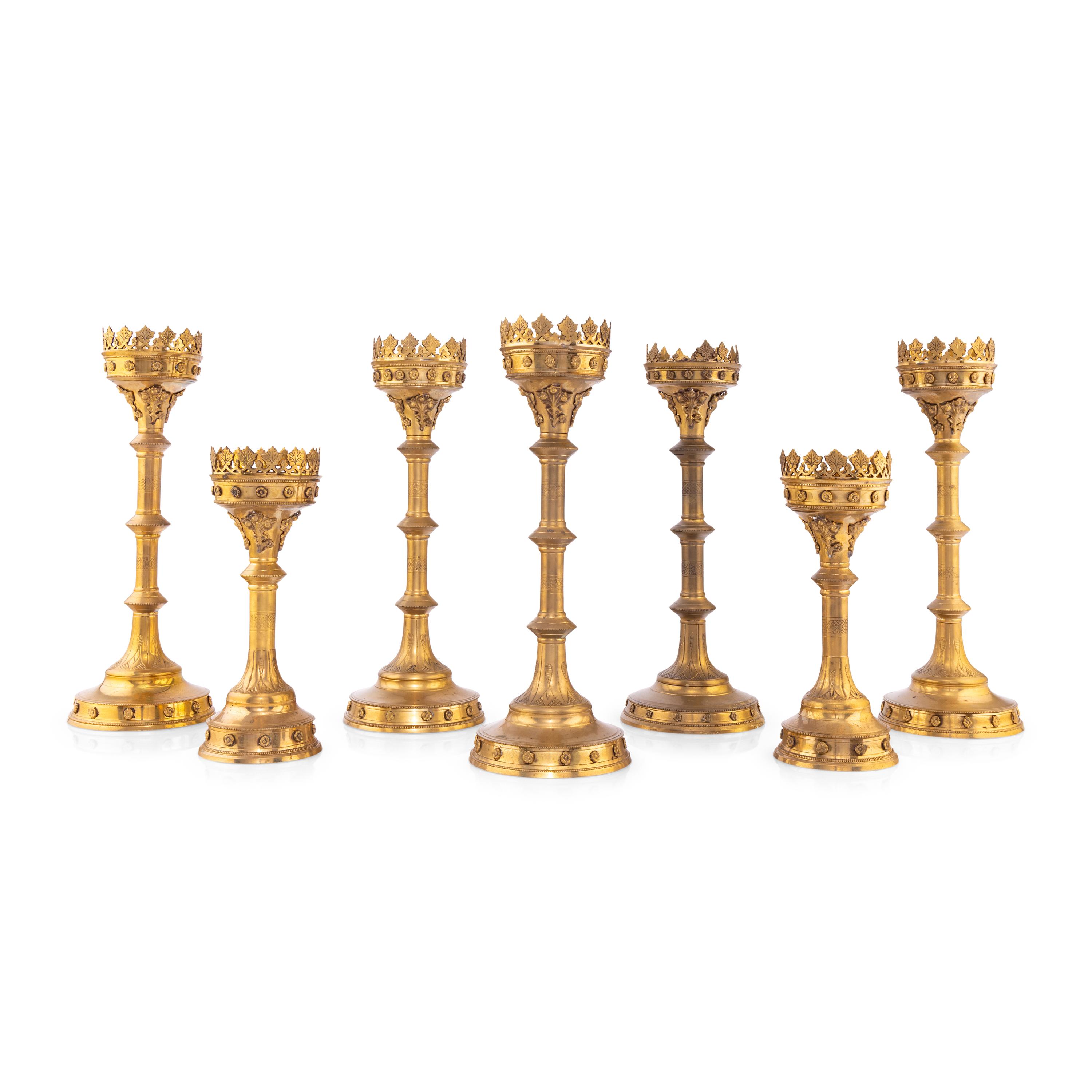 A Collection of Seven Brass Altar Candlesticks