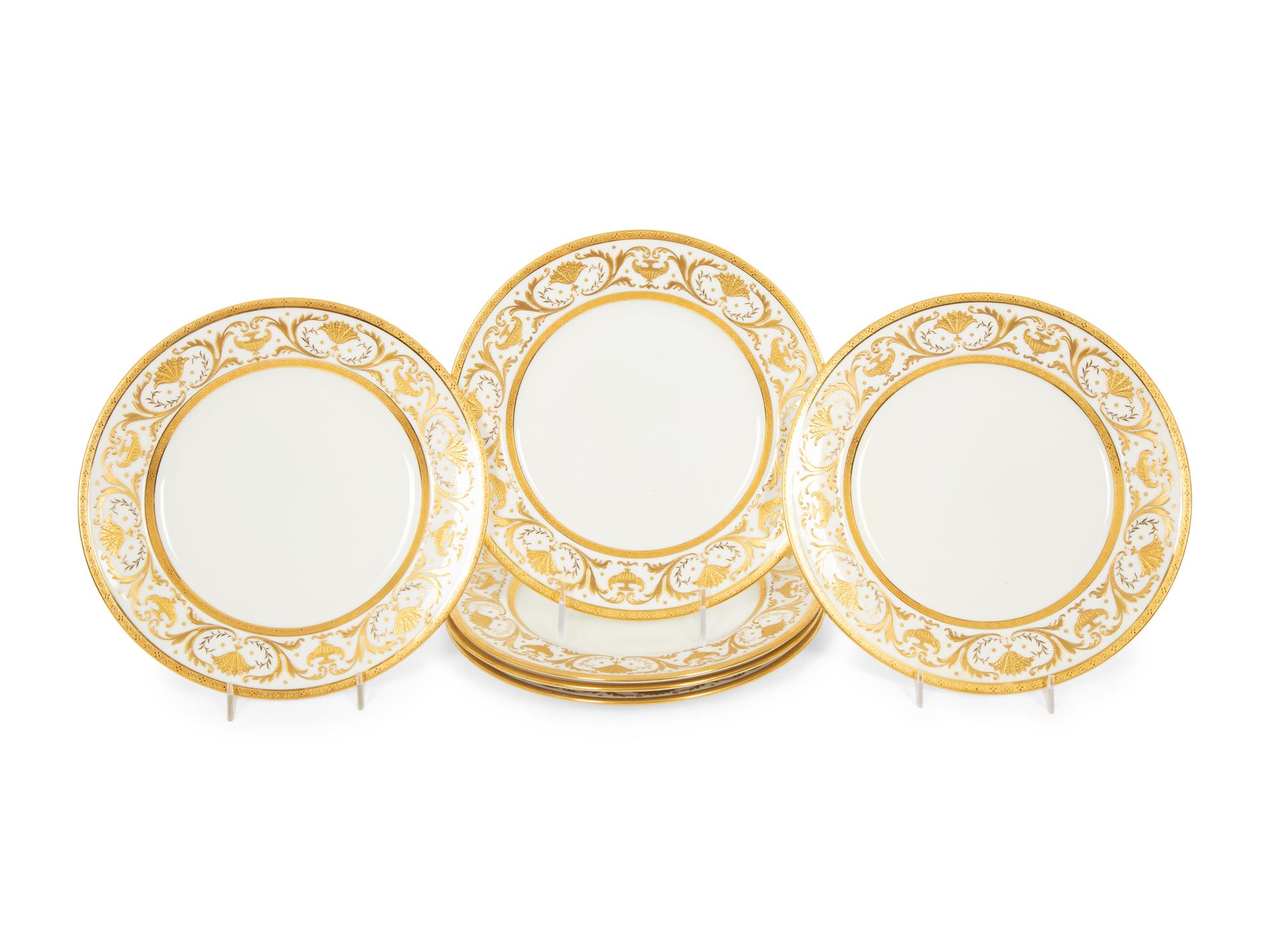 Two Sets of Gilt Decorated Porcelain Dinner Plates