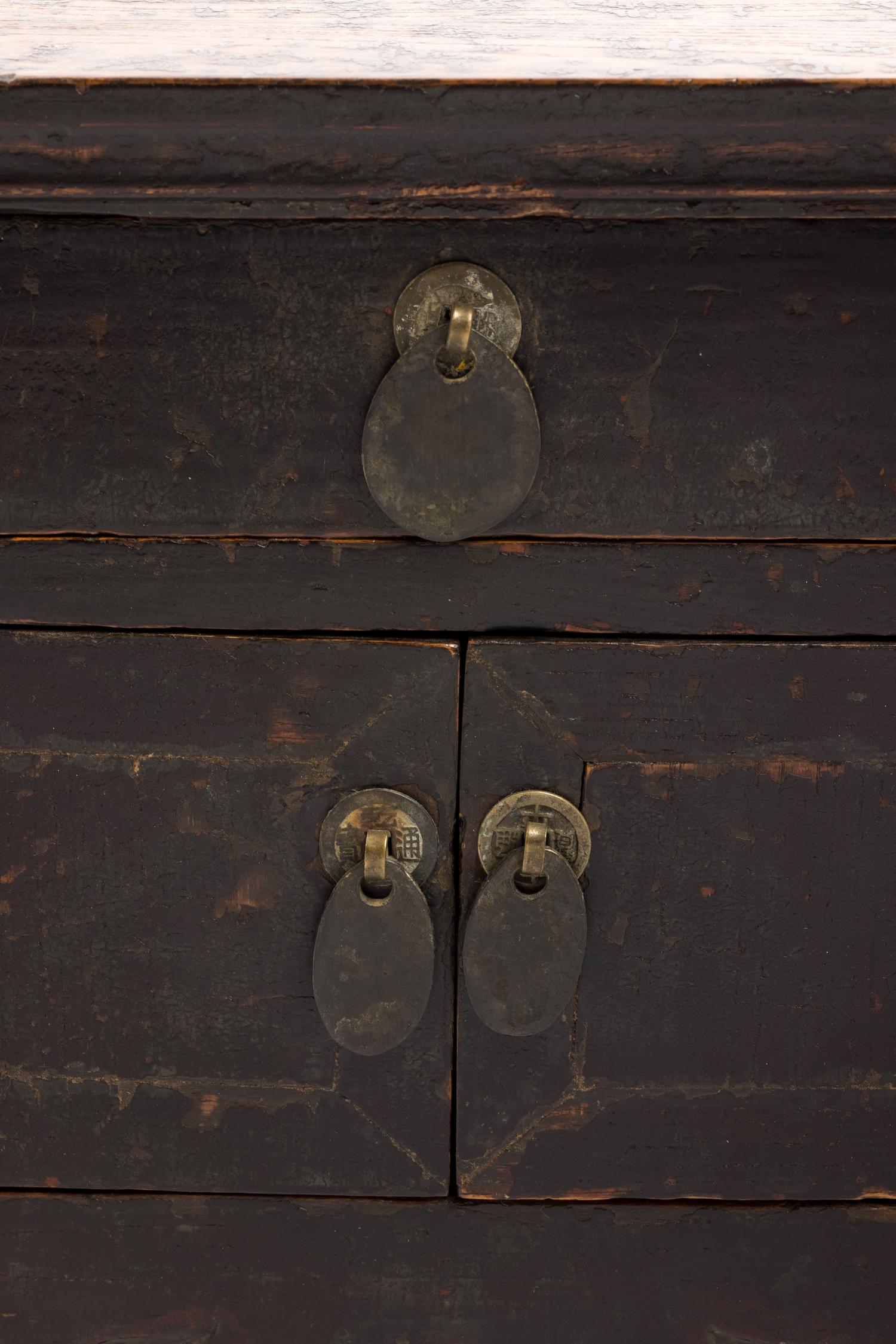 A Chinese Carved and Black Painted Wood Diminutive Chest