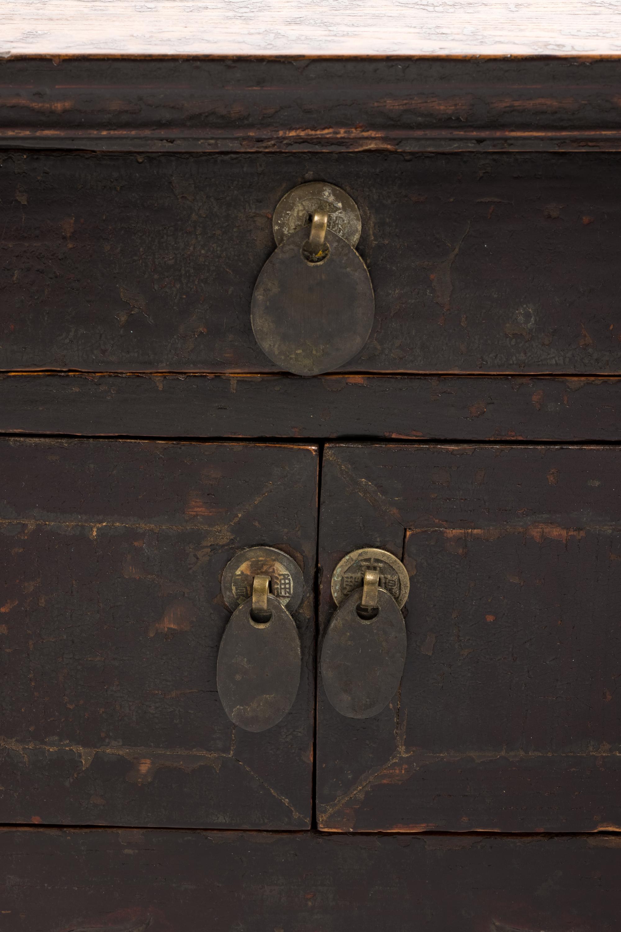 A Chinese Carved and Black Painted Wood Diminutive Chest