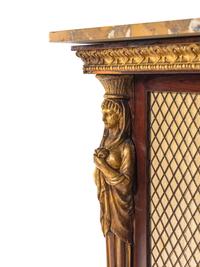 A Regency Egyptian Revival Style Parcel Gilt Rosewood Cabinet