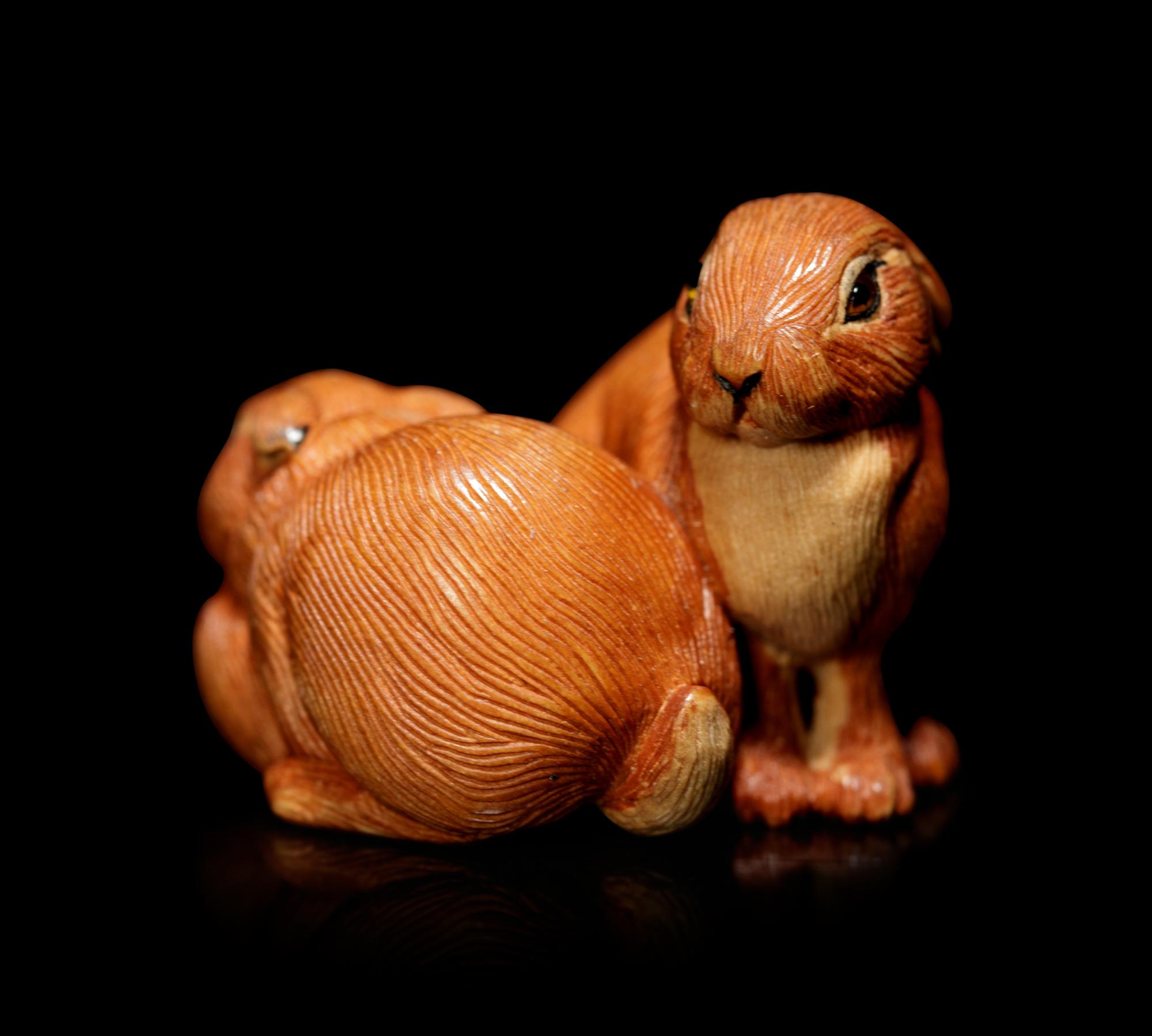 An Amber Inlaid Boxwood 'Leverets' Ojime