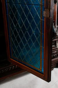 A Continental Renaissance Revival Carved Walnut and Leaded Glass Cabinet