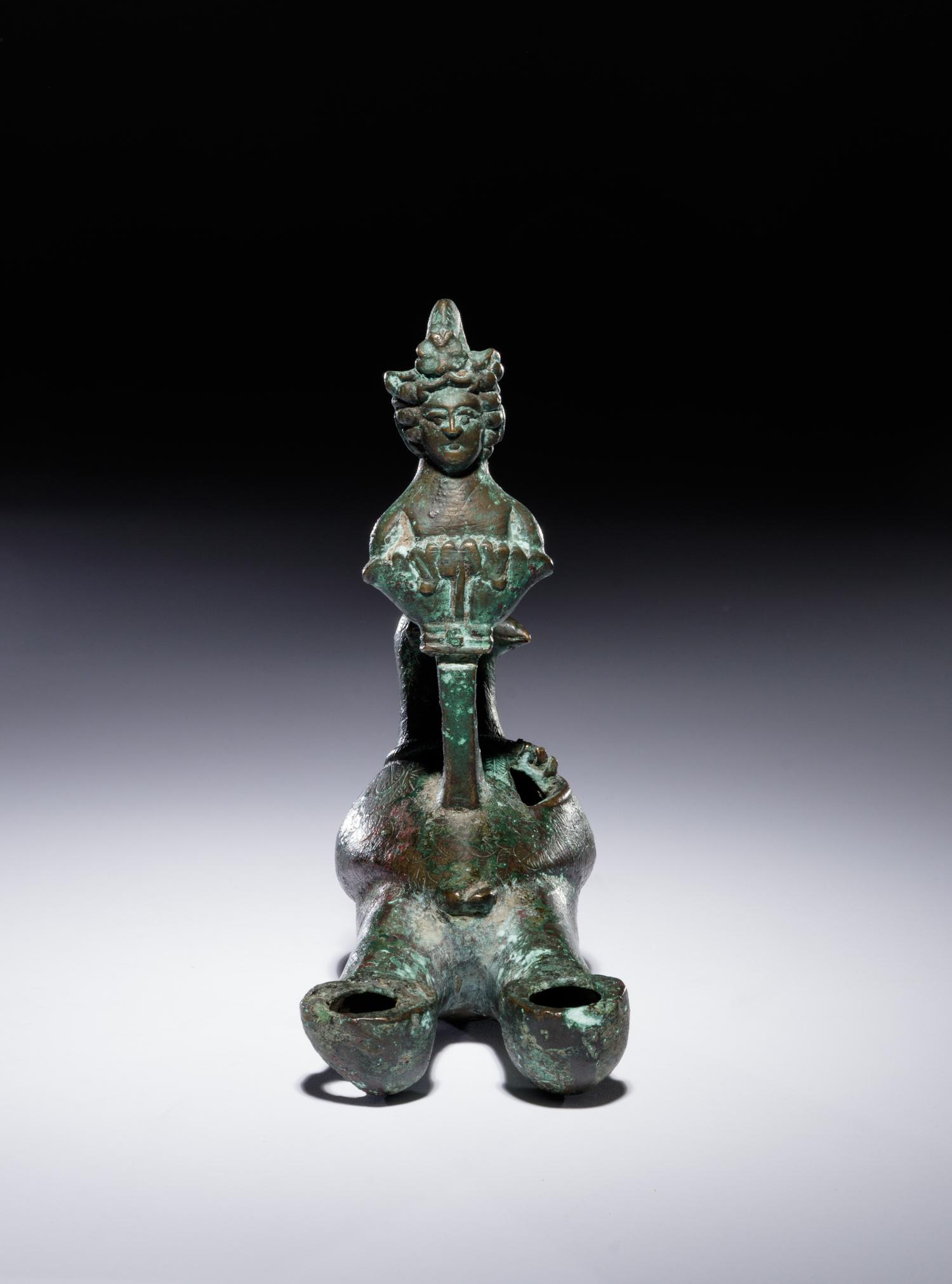 A Roman Bronze Oil Lamp in the Shape of a Dove with the Bust of a Goddess