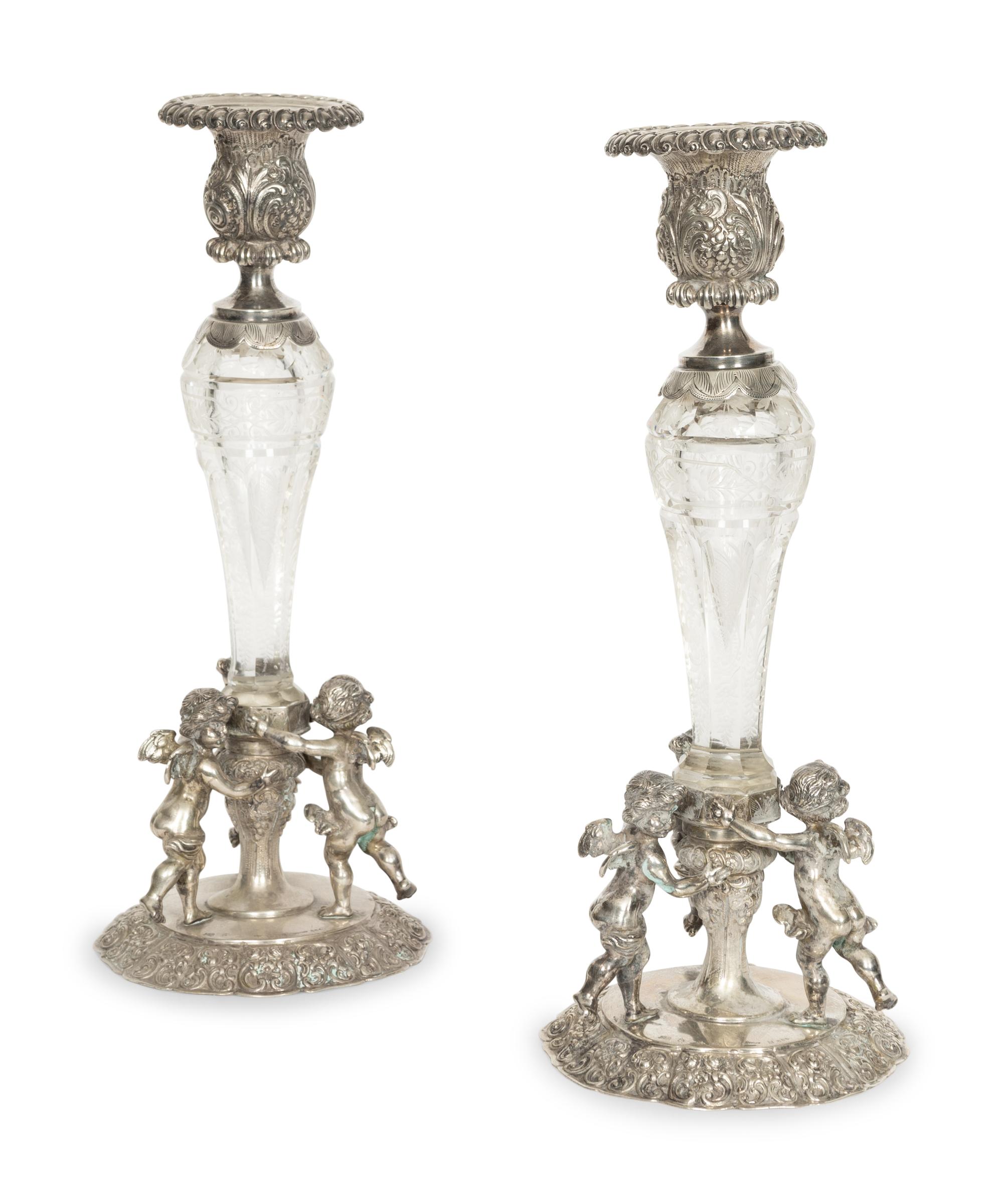 A Pair of German Silver and Cut Glass Figural Candlesticks