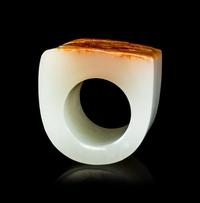 A Chinese White and Russet Jade Archer's Ring