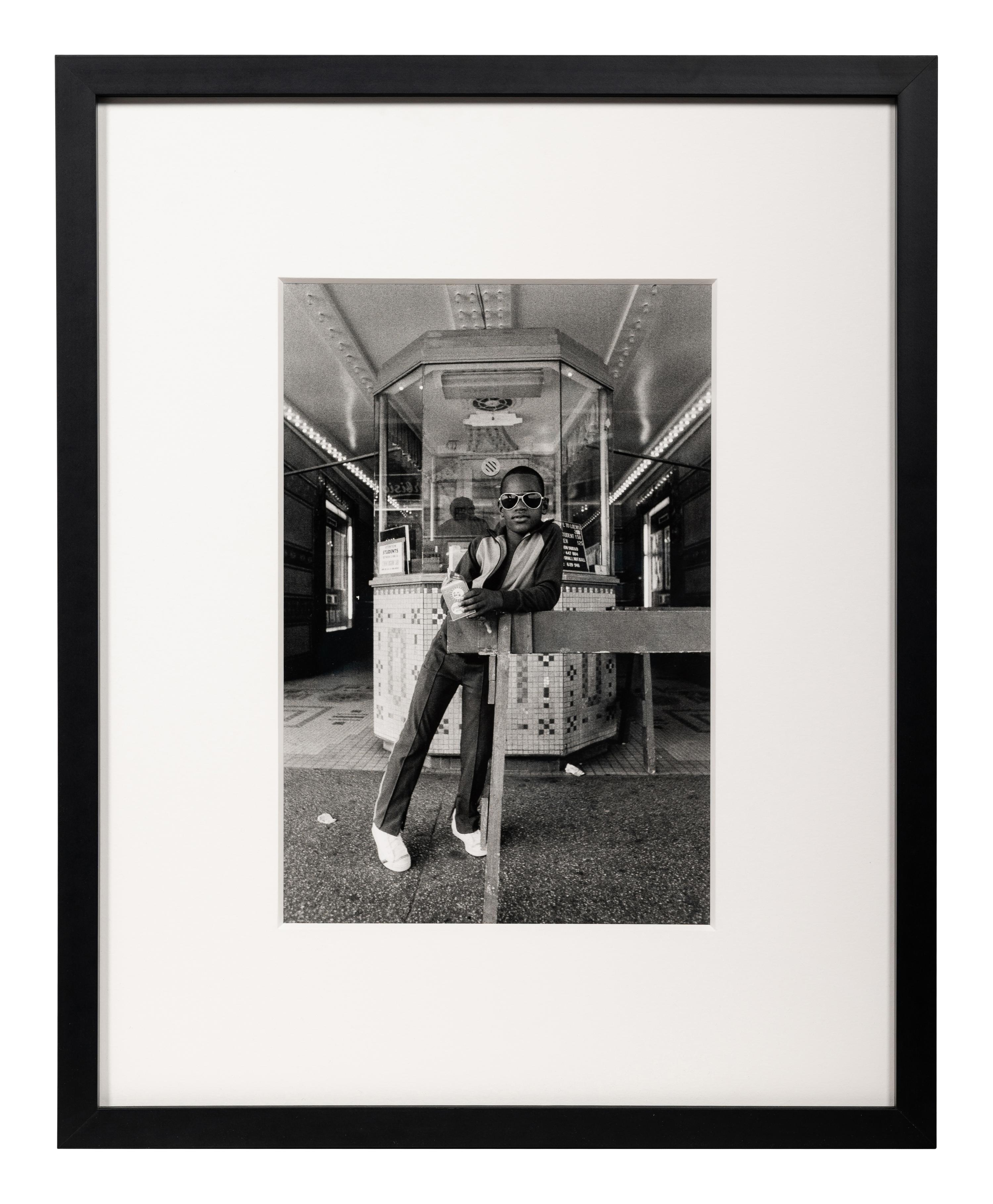 Dawoud Bey (American, b. 1953) — A Boy in Front of the Lowe's 125th Street Movie Theatre, 1976, (printed 2012)