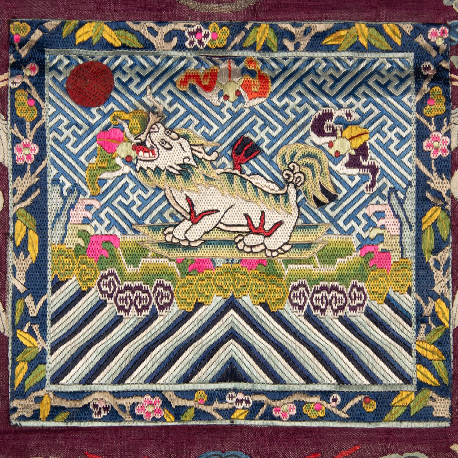 A Chinese Maroon Ground Embroidered and Kesi Silk 'Xiezhi' Rank Badge, Late 19th Century 清晚期 絳紅地緙絲納紗御史獬豸補子