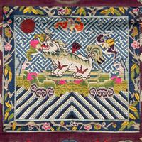 A Chinese Maroon Ground Embroidered and Kesi Silk 'Xiezhi' Rank Badge, Late 19th Century 清晚期 絳紅地緙絲納紗御史獬豸補子