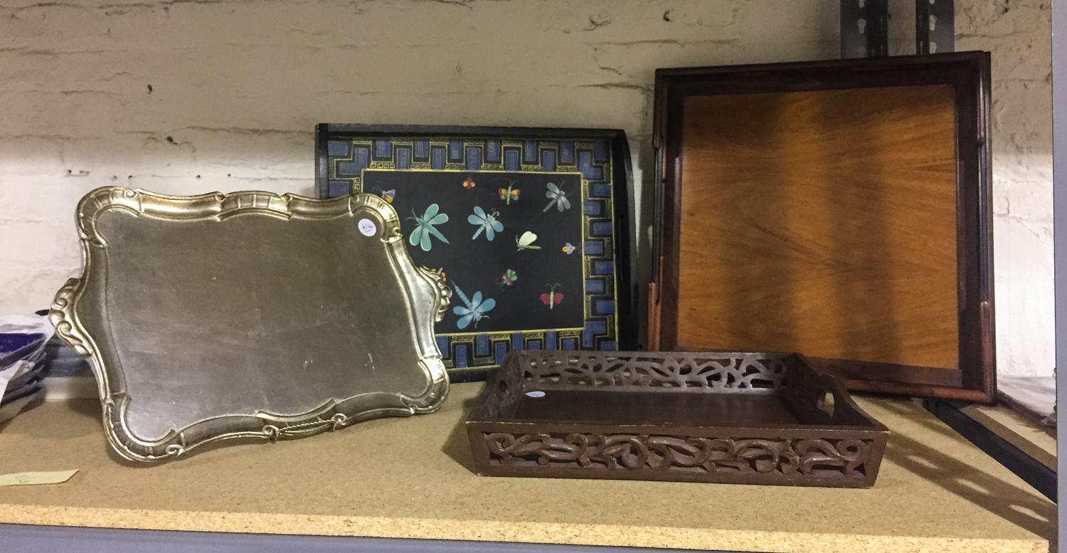 A Group of Four Decorative Trays. Width of widest 21 inches.