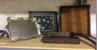 A Group of Four Decorative Trays. Width of widest 21 inches.