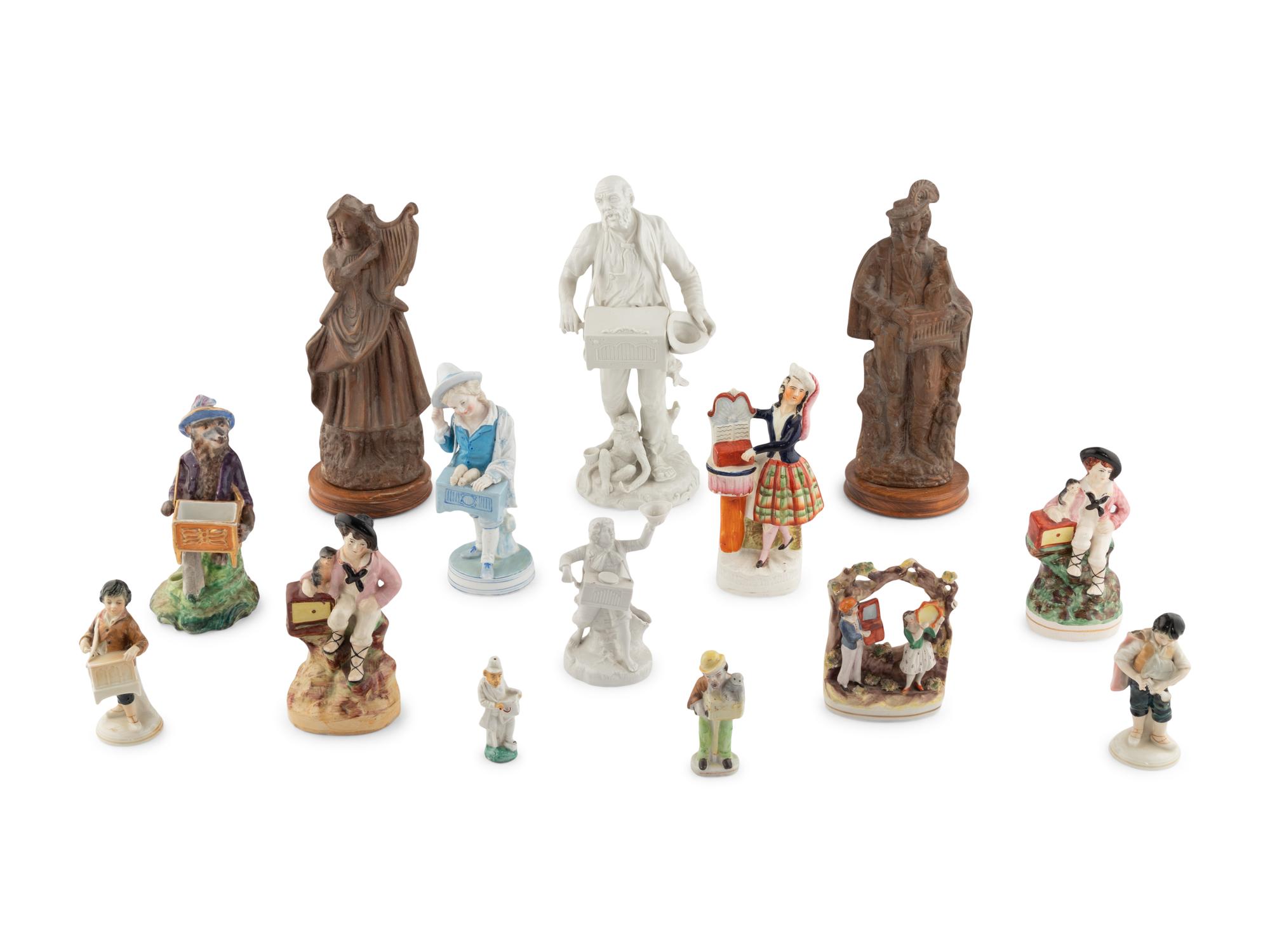 A Group of Fourteen Street Organist Figurines