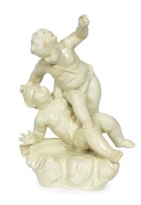 A Continental White-Glazed Faience Putti Group