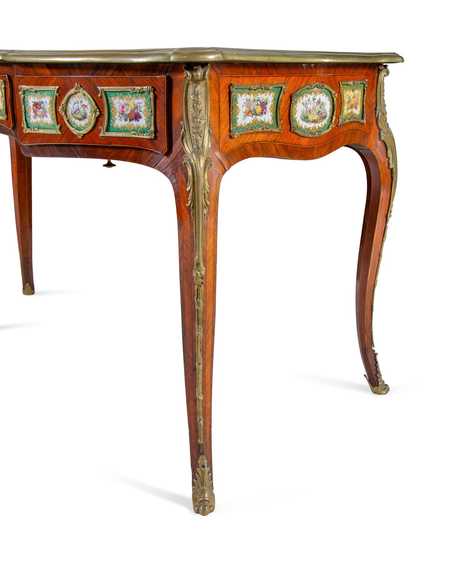 A Louis XV Style Gilt Bronze and Sèvres Style Porcelain Mounted Kingwood Bureau Plat