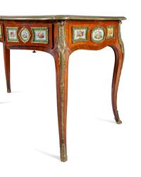 A Louis XV Style Gilt Bronze and Sèvres Style Porcelain Mounted Kingwood Bureau Plat