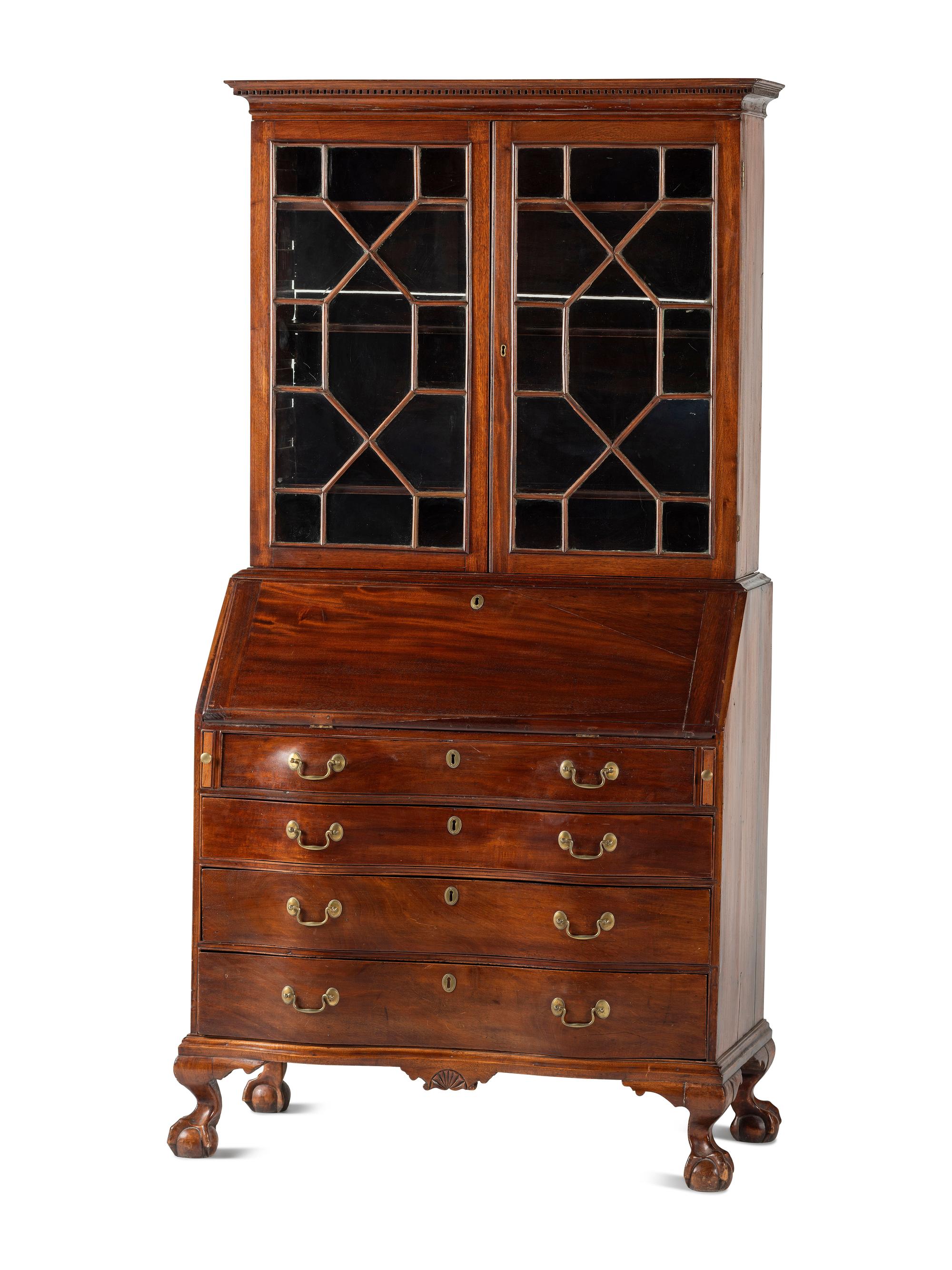 A Chippendale Mahogany and Cherrywood Serpentine Claw-and-Ball Foot Desk-and-Bookcase