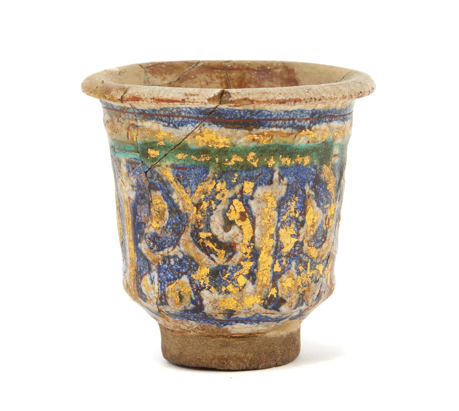 An Islamic Blue, Green and Iridescent Gold Glazed Pottery Cup Height 2 7/8 inches. — CIRCA 12TH CENTURY