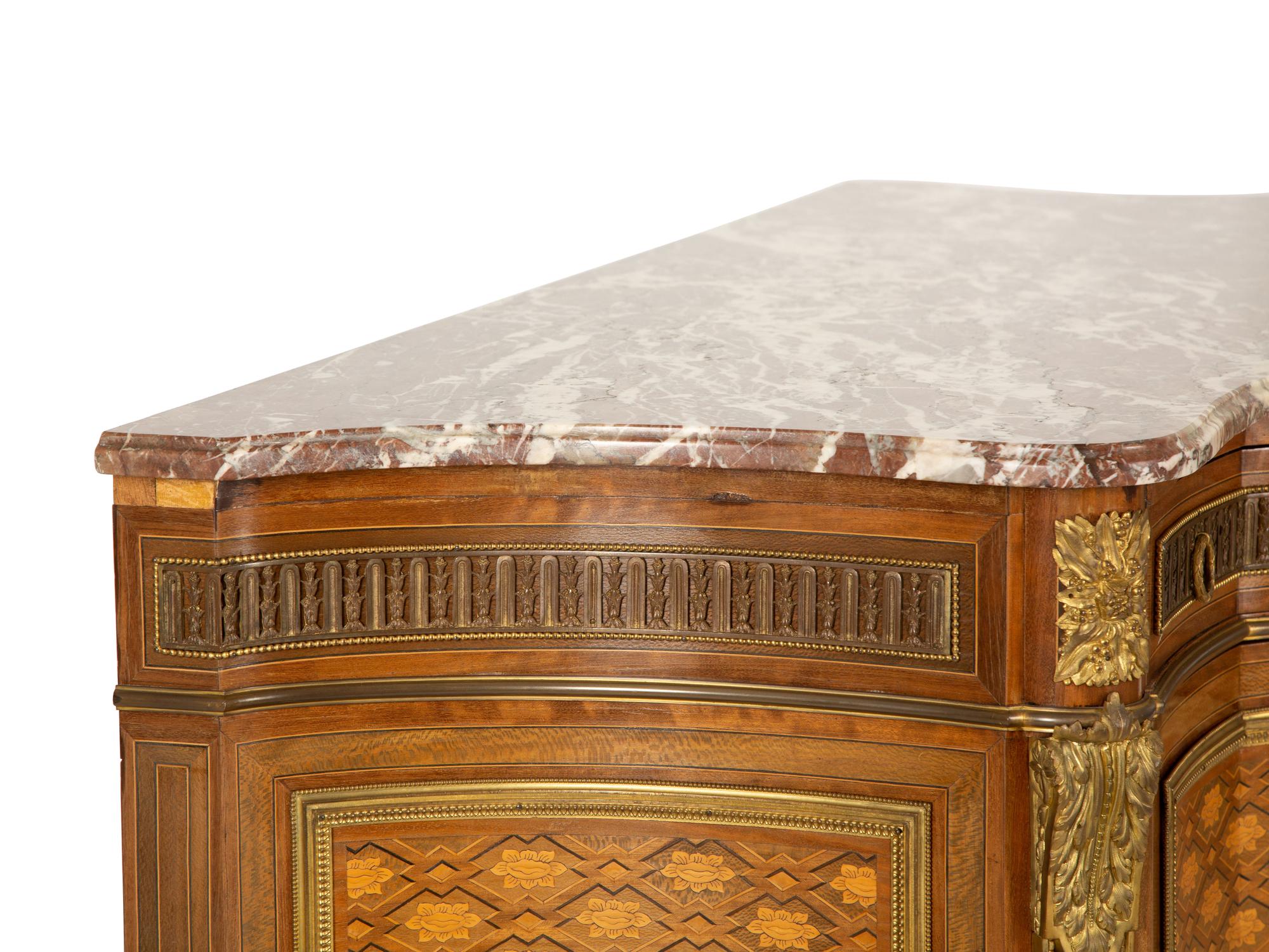 A Louis XVI Style Gilt Bronze Mounted Kingwood and Marquetry Marble-Top Commode