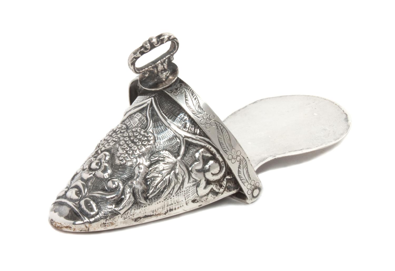 A Peruvian Silver Ornamental Stirrup, , chased with fruit and flowers.