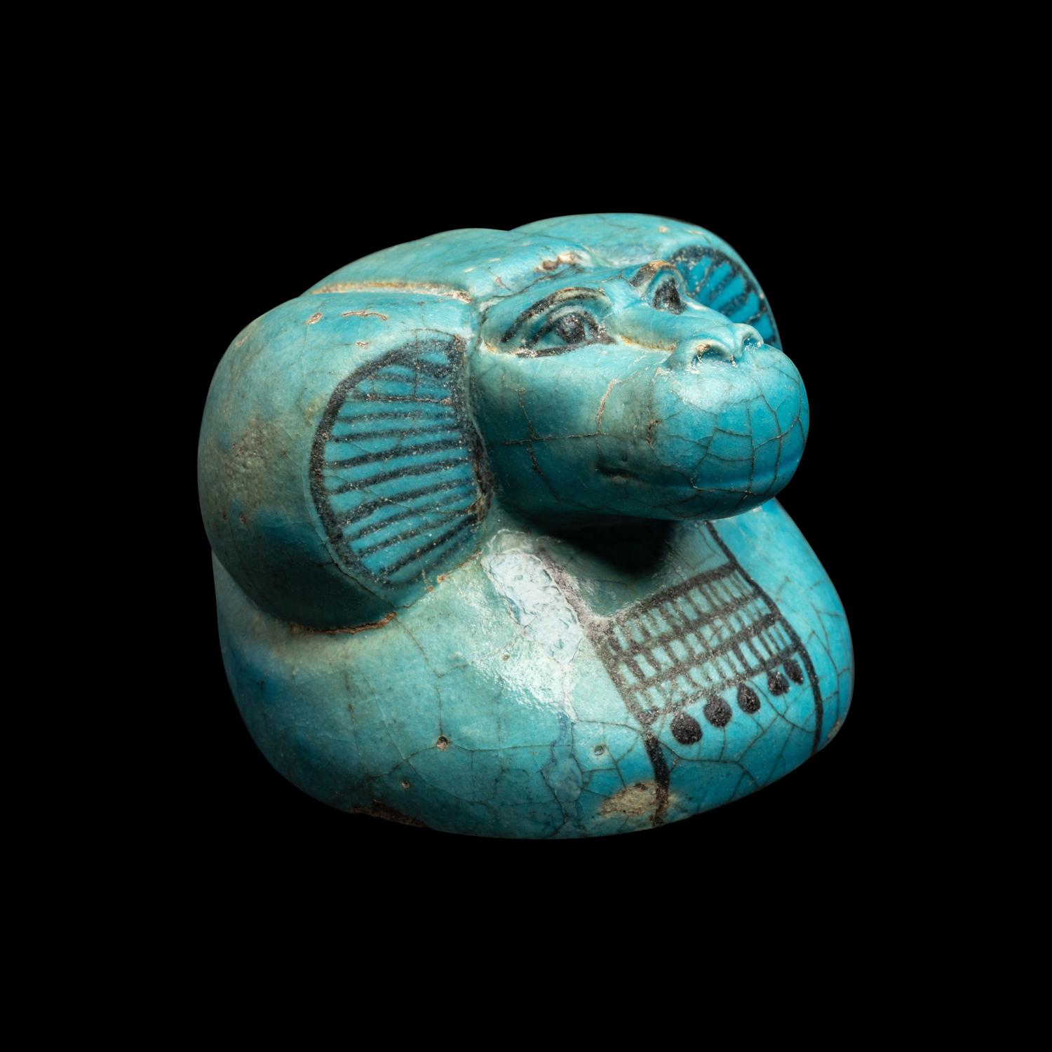 An Egyptian Blue Faience Canopic Jar Lid with the Head of a Baboon (Hapi)