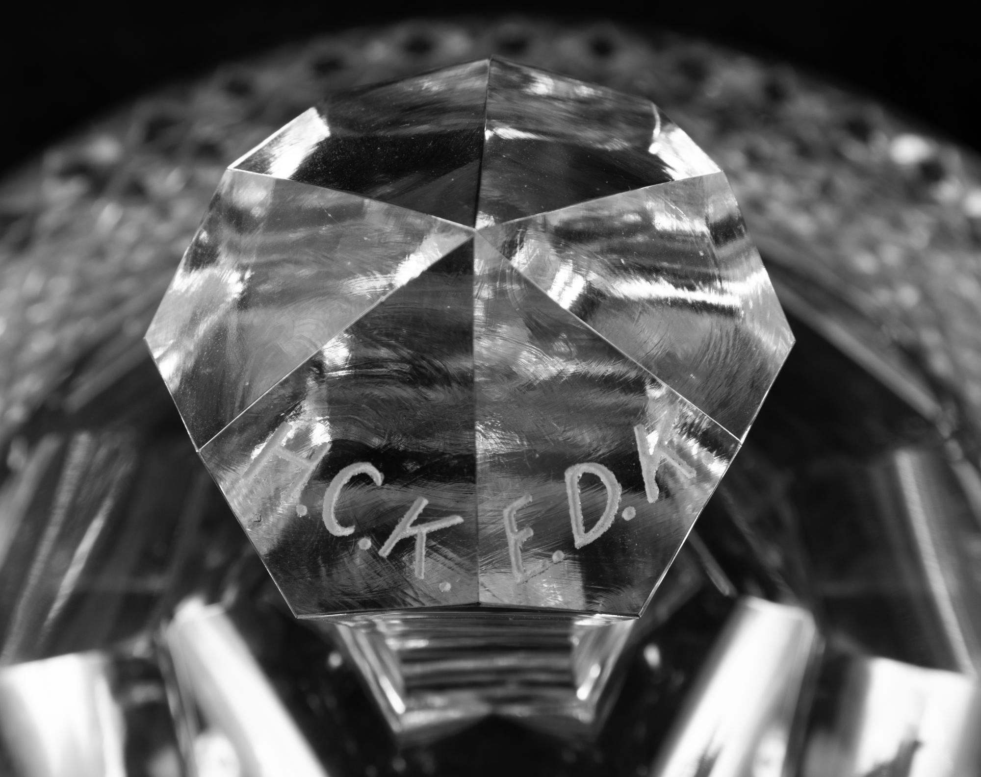 A Near Pair of Cut and Etched Glass Commemorative Covered Urns
