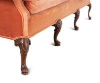 A George III Style Carved Mahogany Camel Back Sofa