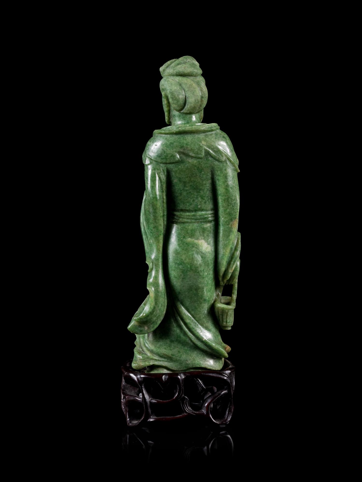 A Mottled Green Jade Figure of Guanyin