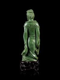 A Mottled Green Jade Figure of Guanyin