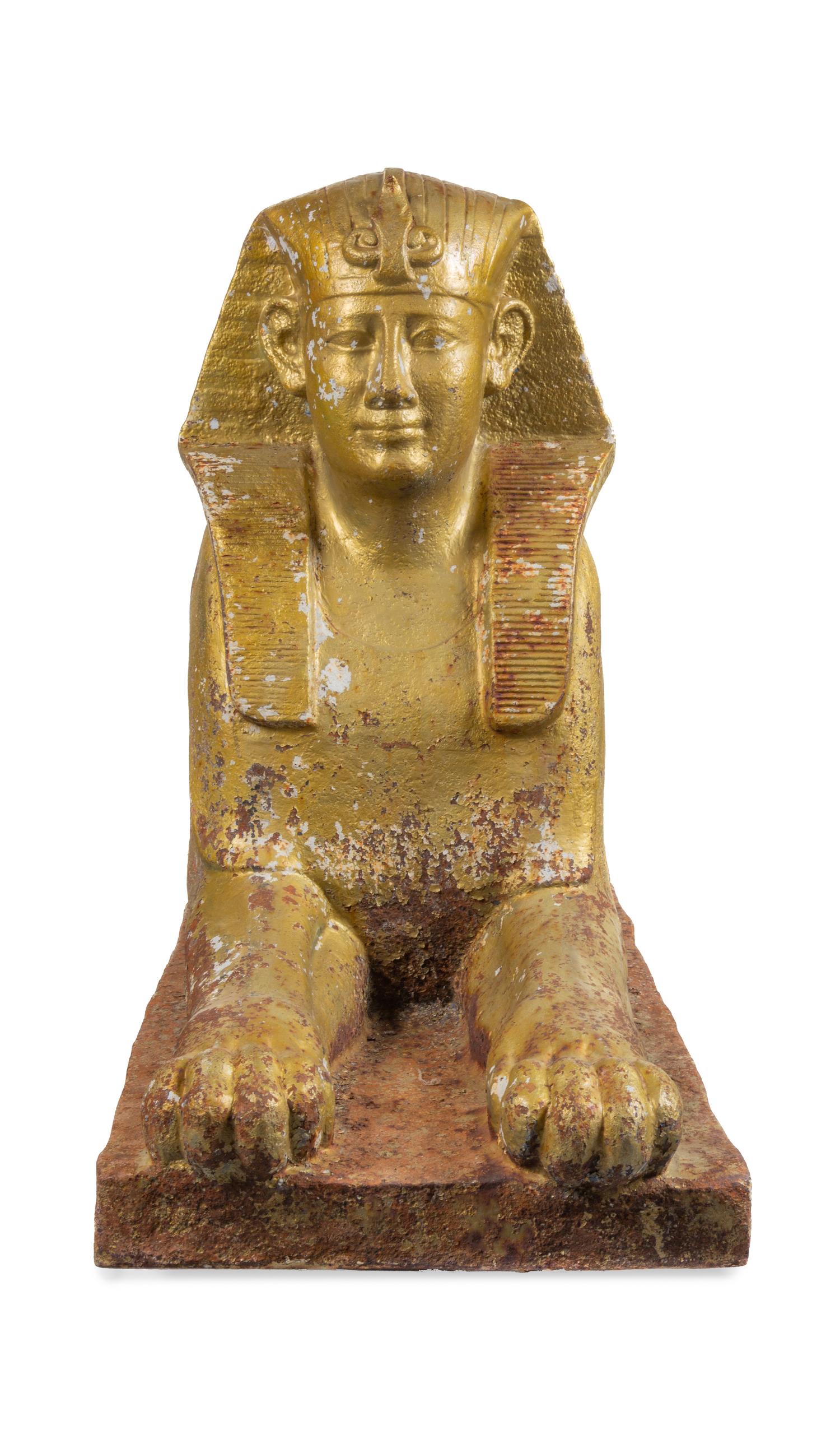 A Gold-Painted Cast Iron Model of a Sphinx Height 33 x width 19 x depth 59 inches. — 19TH CENTURY