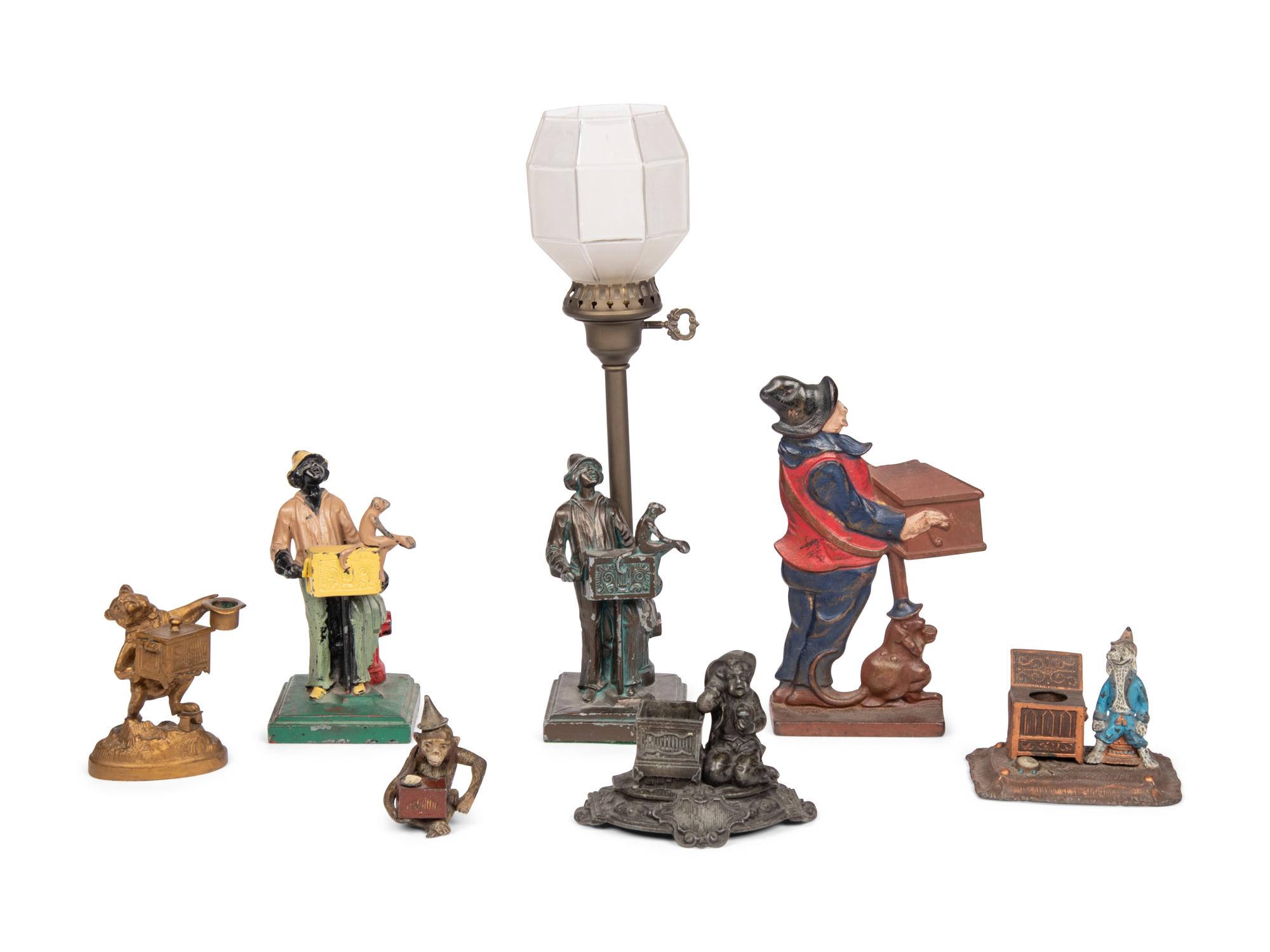 A Group of Seven Barrel Organ Themed Metal Items
