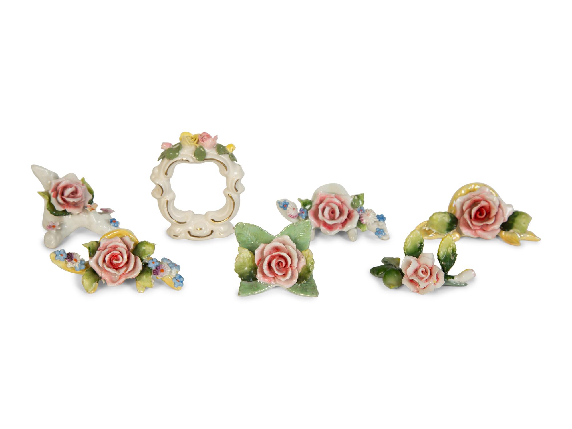 A Collection of Dresden Porcelain Place Cards, Holders and Napkin Rings