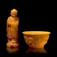A Chinese Carved Stone "Luohan" Seal and a Yellow "Peking" Glass Bowl 壽山石雕羅漢和黃料花卉紋盌各一