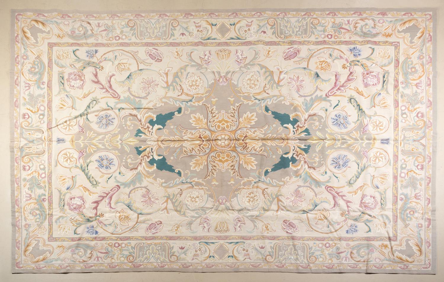 A Textile Needle Point Rug 13 feet 5 inches x 9 feet 4 1/2 inches.