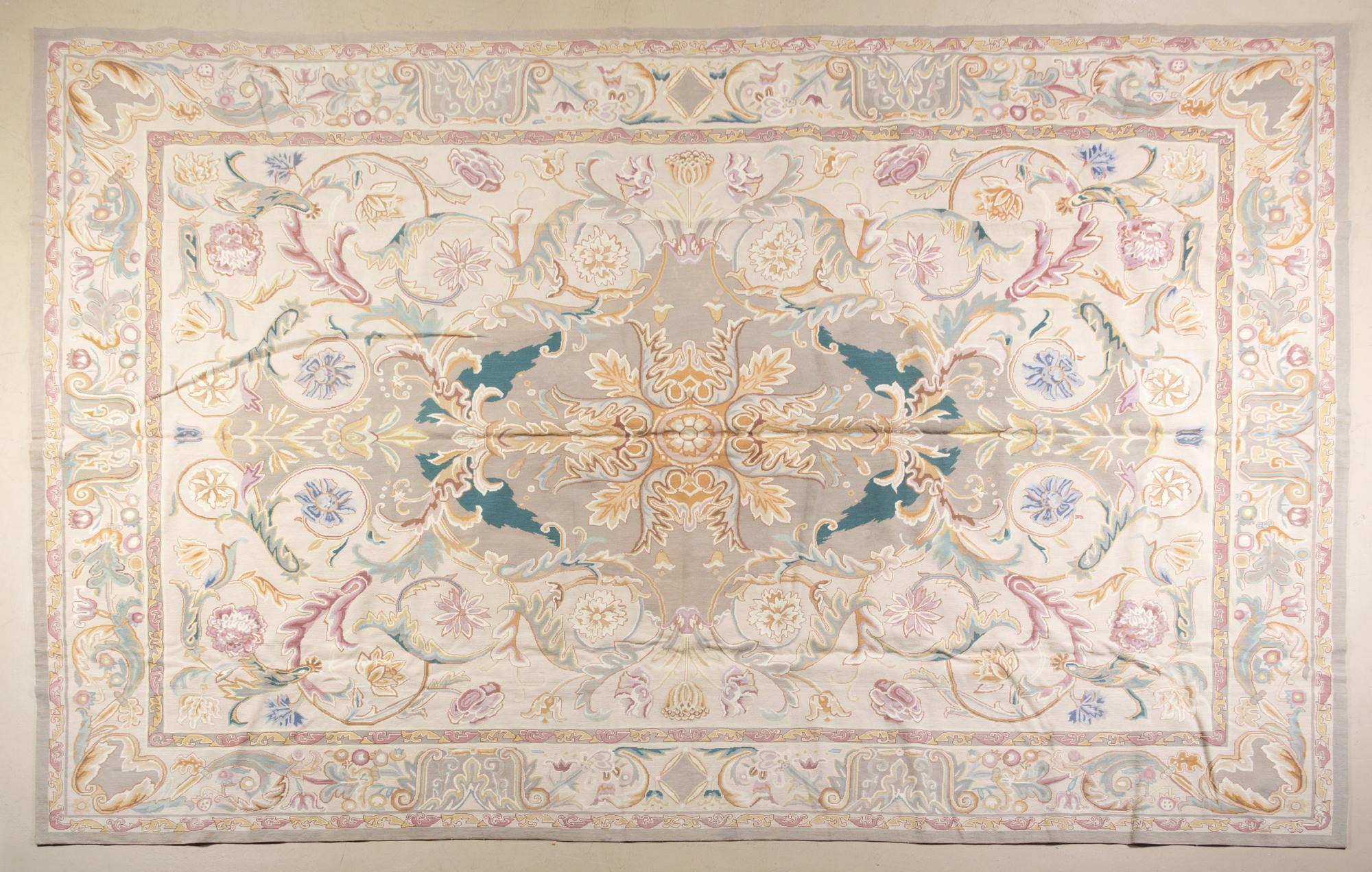A Textile Needle Point Rug 13 feet 5 inches x 9 feet 4 1/2 inches.