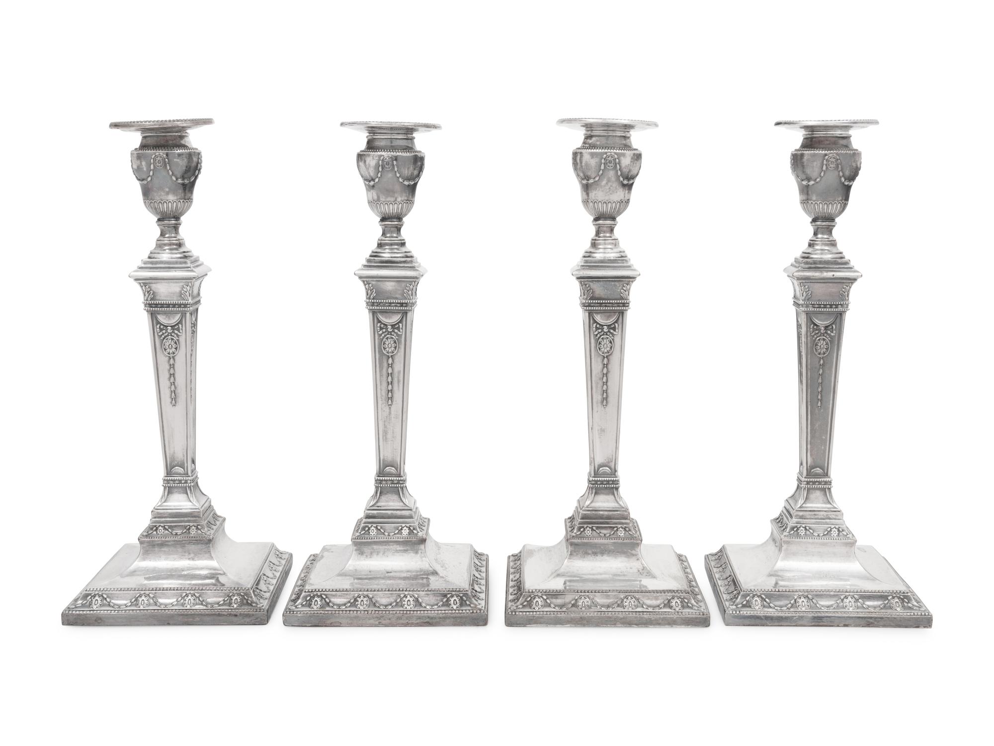 A Set of Four Silver-Plate Candlesticks