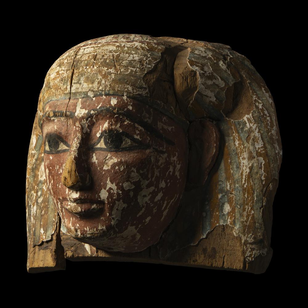 An Egyptian Painted Wood Sarcophagus Head
