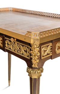 A Louis XVI Style Gilt Bronze Mounted Mahogany and Parquetry Table