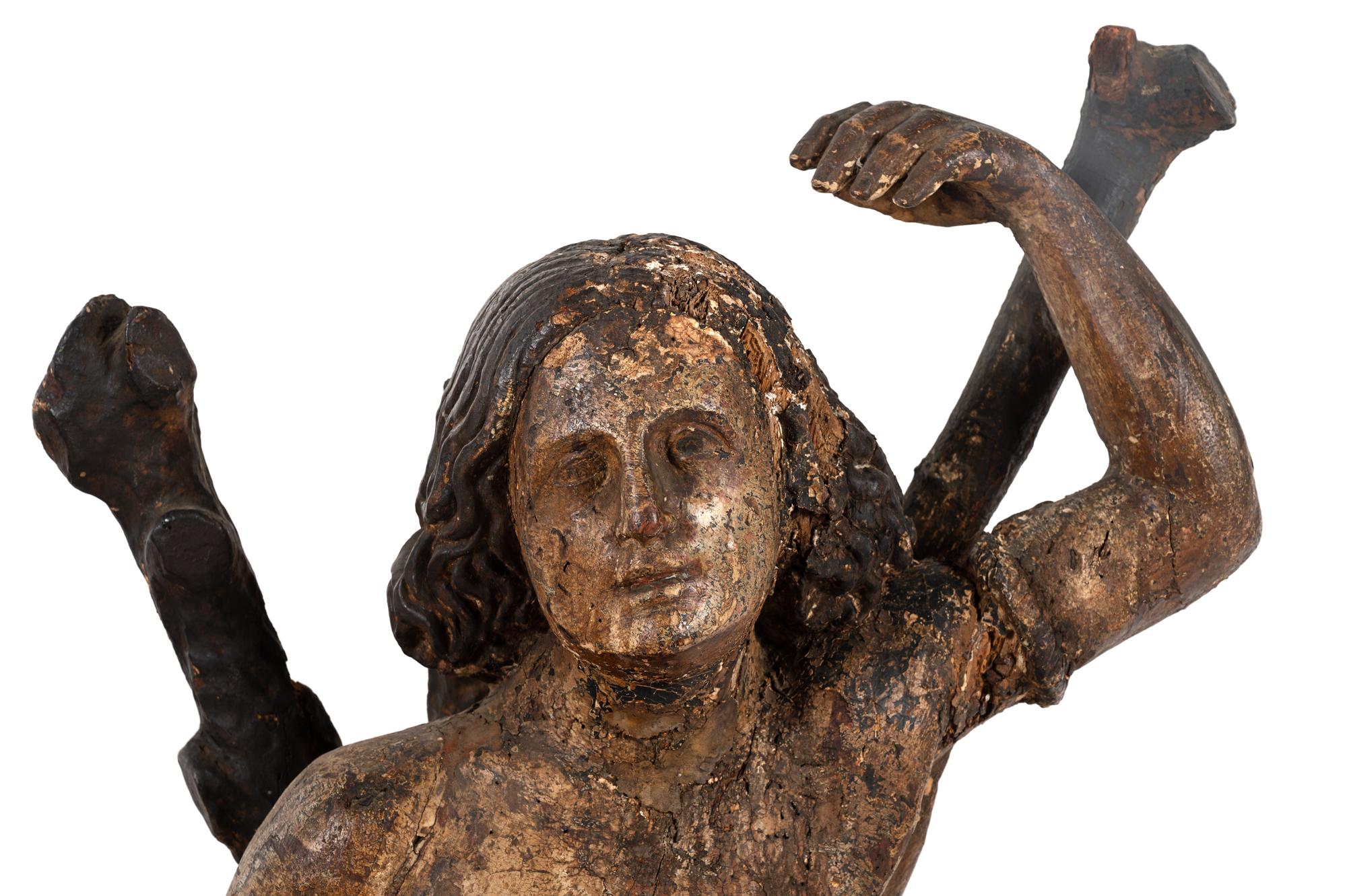 An Italian Carved and Polychromed Figure of St. Sebastian Tied to the Tree