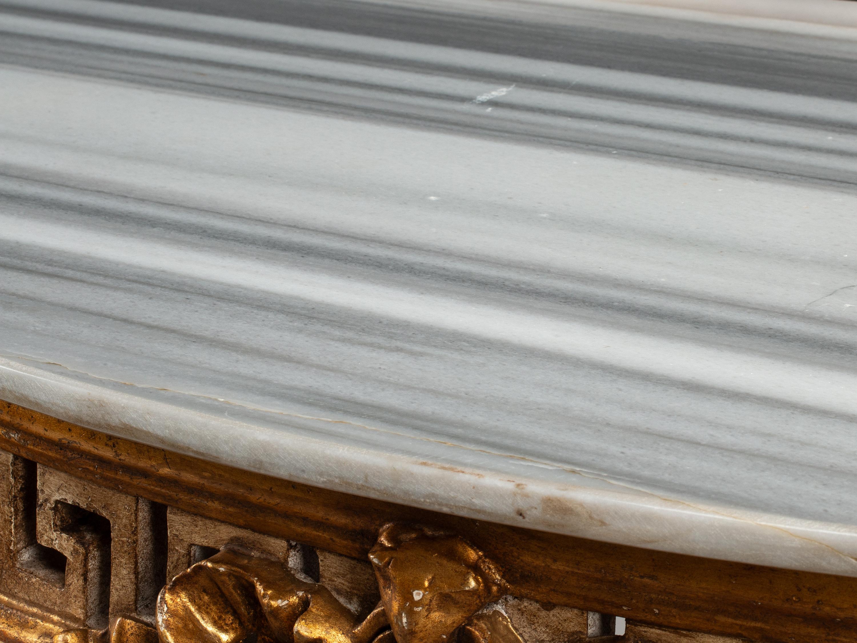 A Pair of Italian Neoclassical Style White Painted and Parcel Gilt Marble-Top Console Tables
