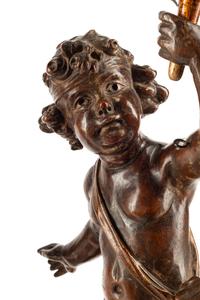 A Pair of Continental Carved Walnut Figures of Putti