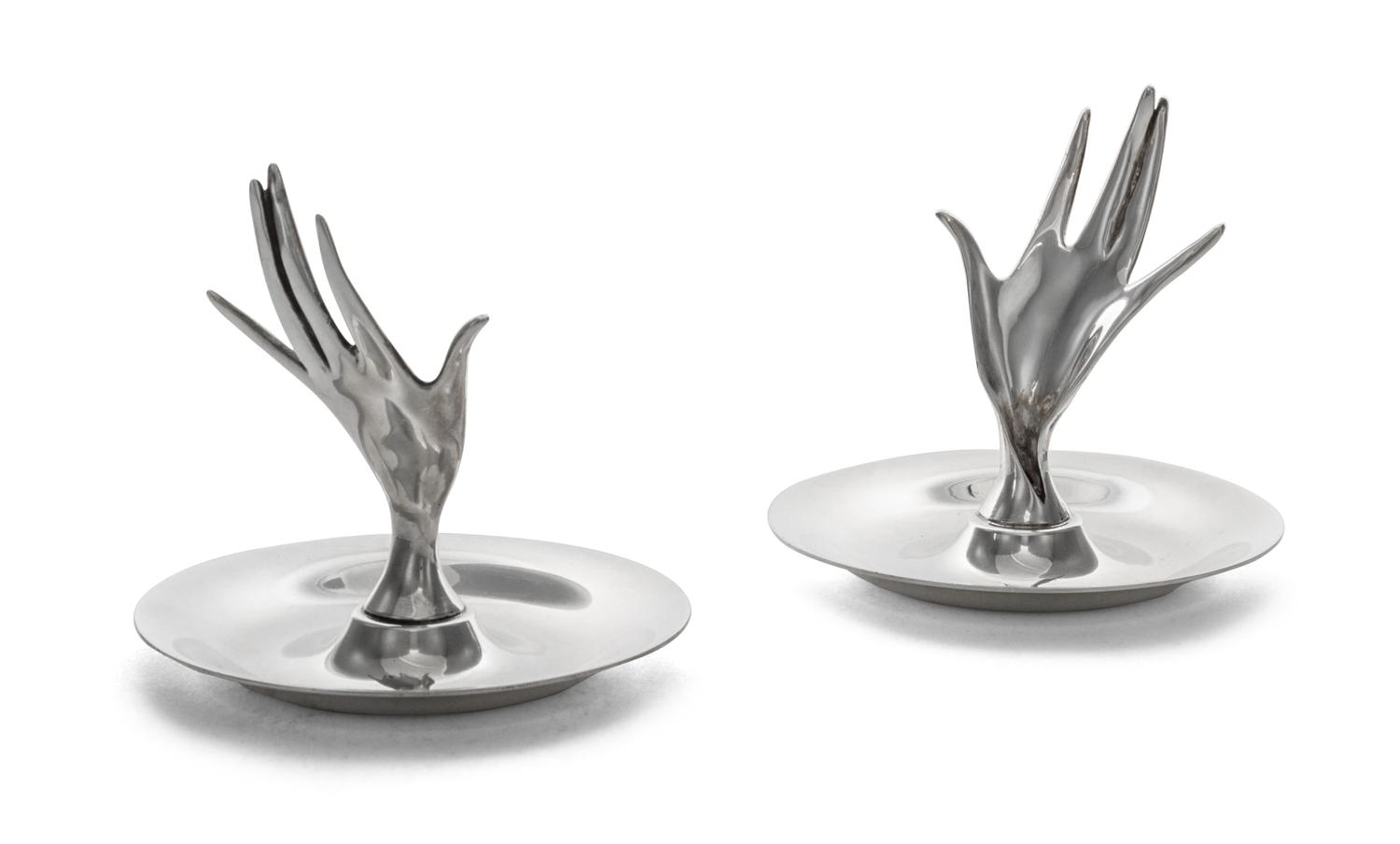 A Pair of American Silver Ring Trays, Tiffany & Co., New York, NY, each formed as a circular dish with a modernist hand rising from the
