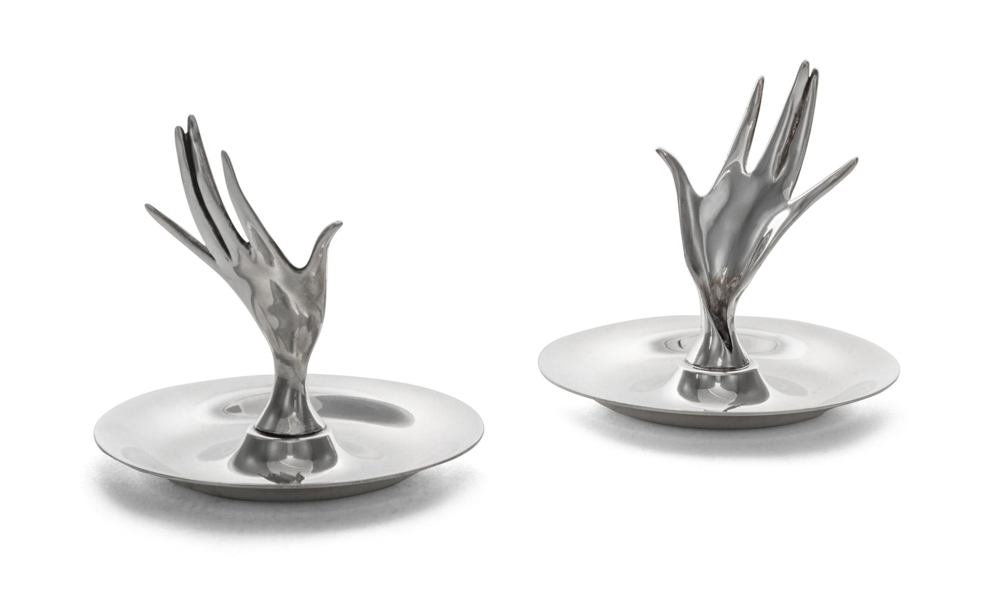 A Pair of American Silver Ring Trays, Tiffany & Co., New York, NY, each formed as a circular dish with a modernist hand rising from the