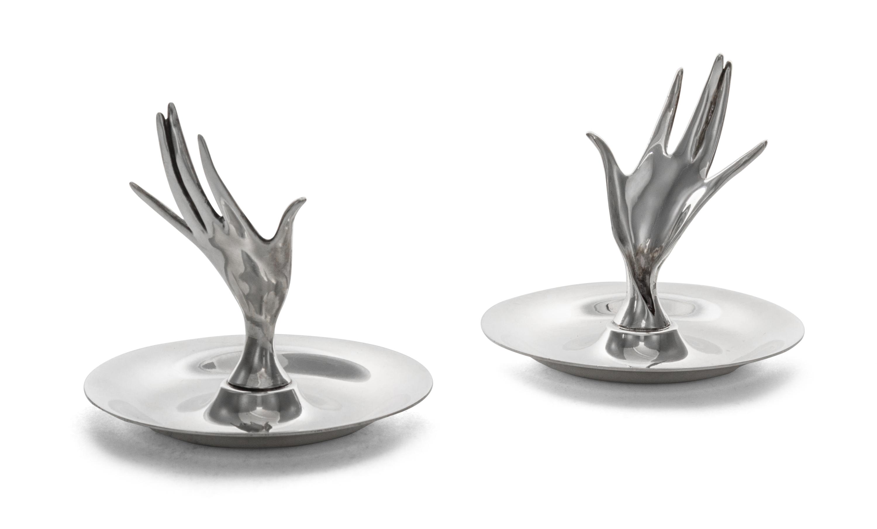 A Pair of American Silver Ring Trays, Tiffany & Co., New York, NY, each formed as a circular dish with a modernist hand rising from the
