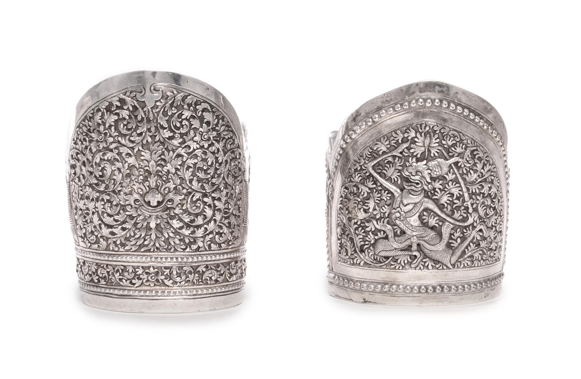 Two Southeast Asian Silver Bangles, , one with scrolling foliate decoration, the other with a dancing figure.