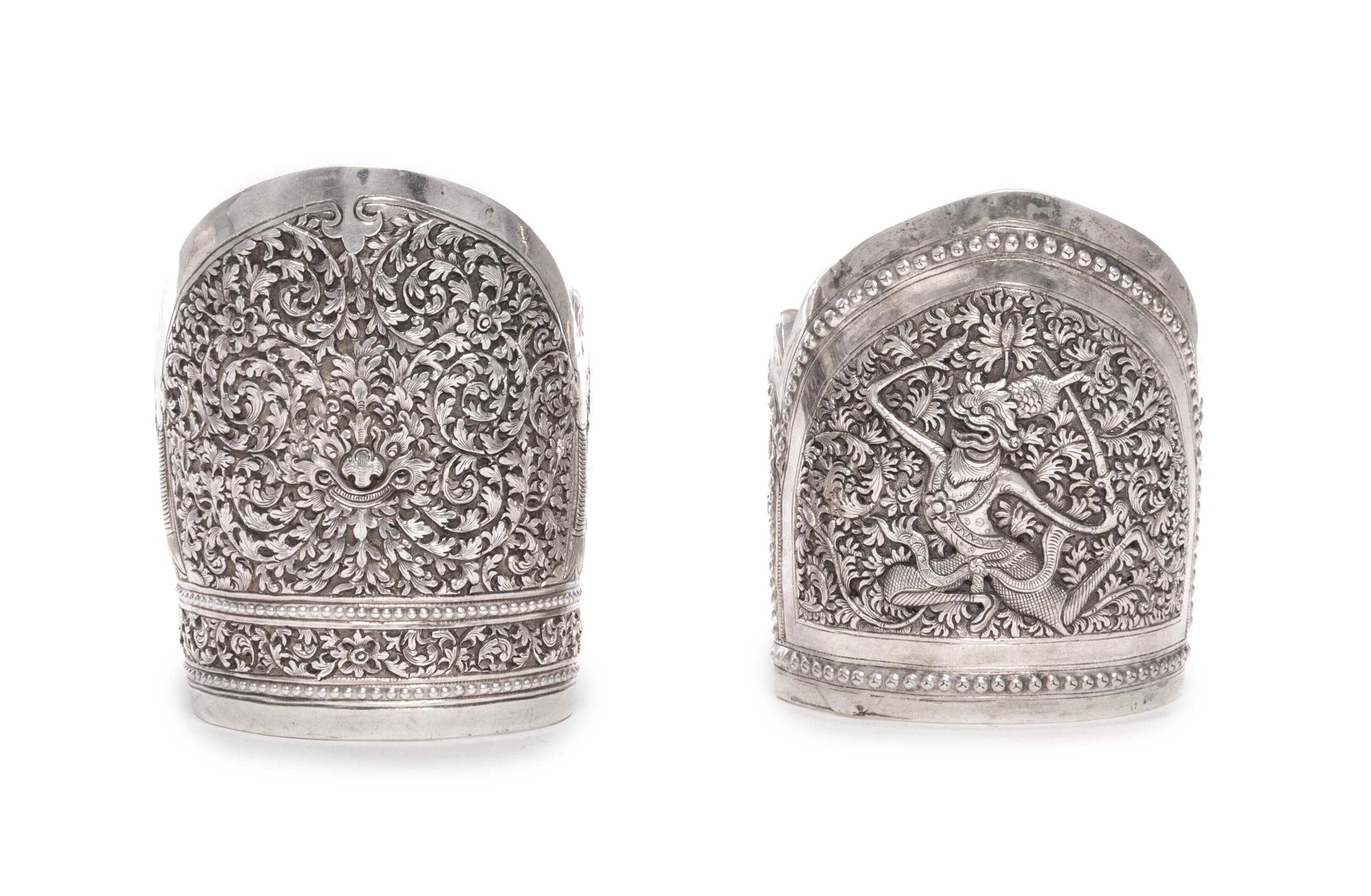 Two Southeast Asian Silver Bangles, , one with scrolling foliate decoration, the other with a dancing figure.