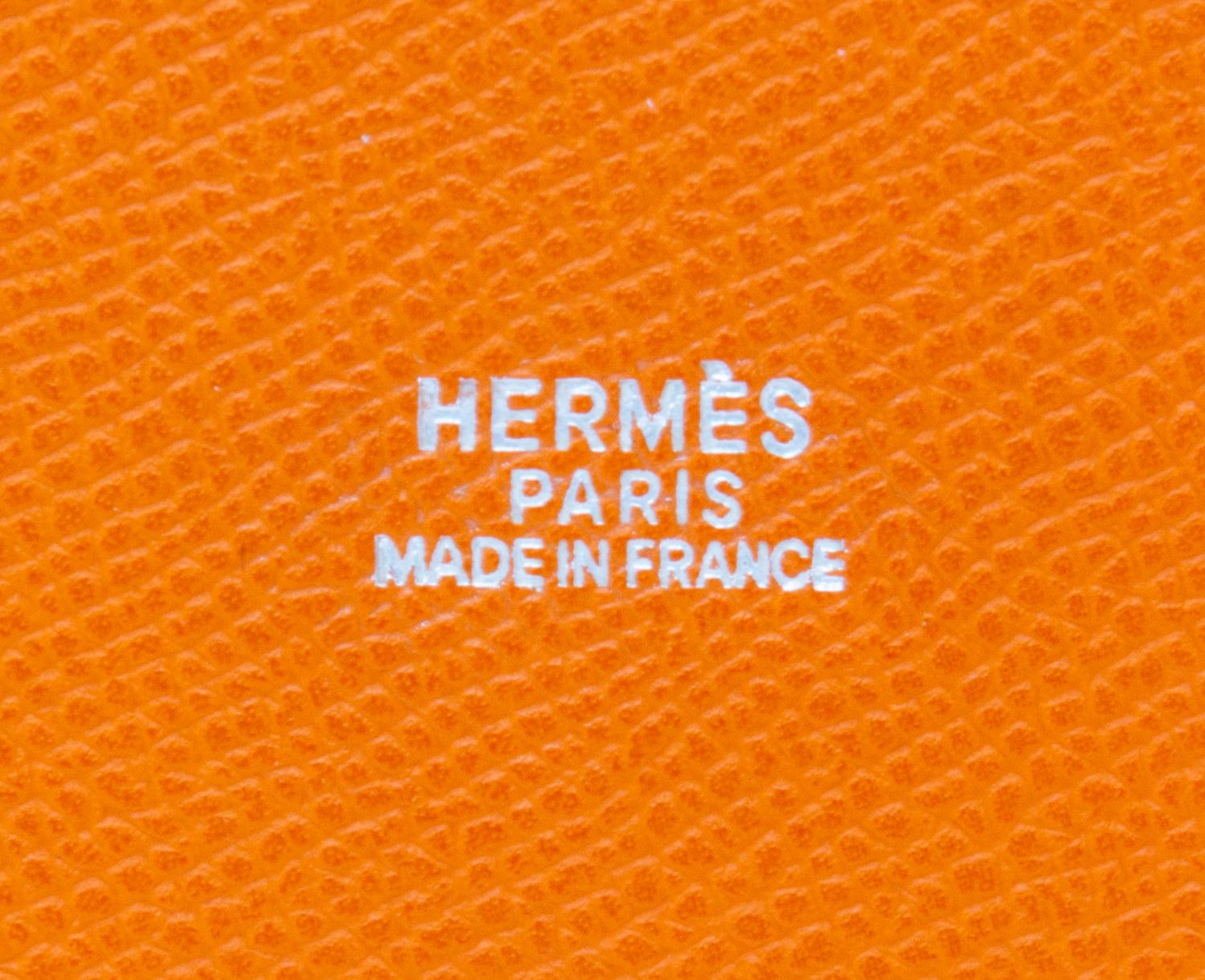 An Hermes Orange Clemence Feed Handbag, 6.75" x 7.25" x 5".