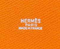 An Hermes Orange Clemence Feed Handbag, 6.75" x 7.25" x 5".