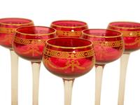 A Set of Twelve Bohemian Gilt Decorated Cranberry Glass Stemmed White Wines — 19th/20th Century